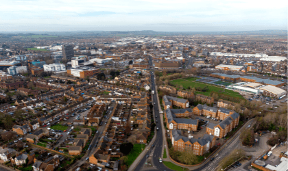 Bird's eye view of a sprawling English town with urban, residential and industrial areas.