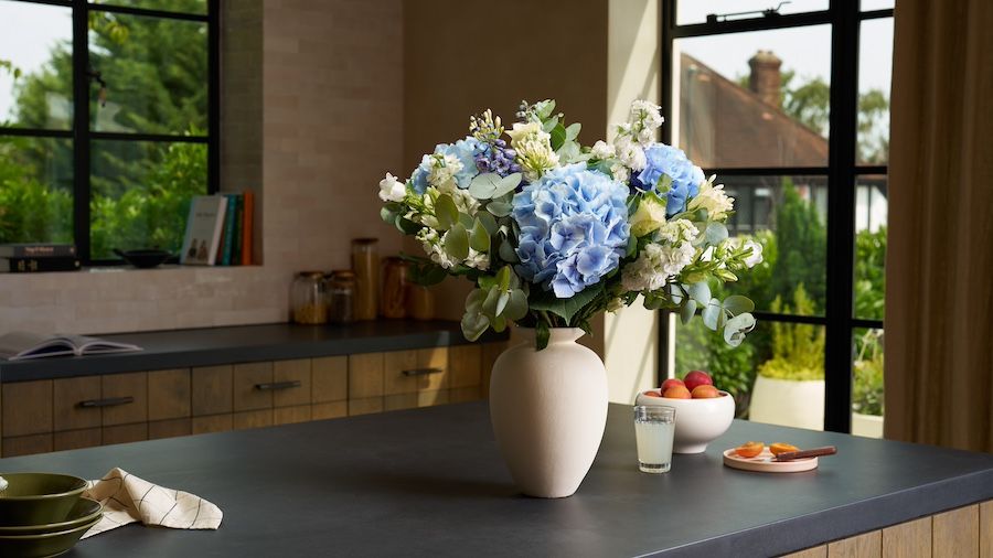 A bouquet of hydrangeas and delphiniums on a central kitchen island