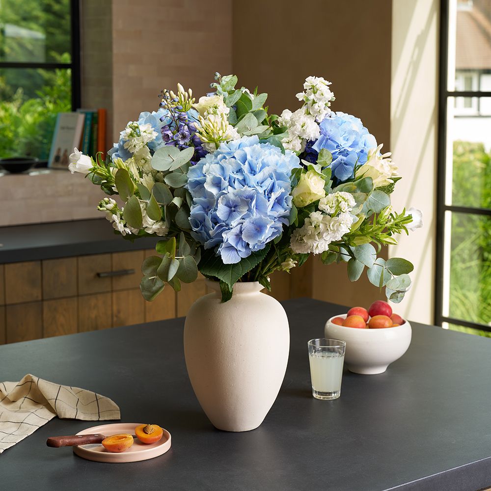 A blue hydrangea and delphinium bouquet