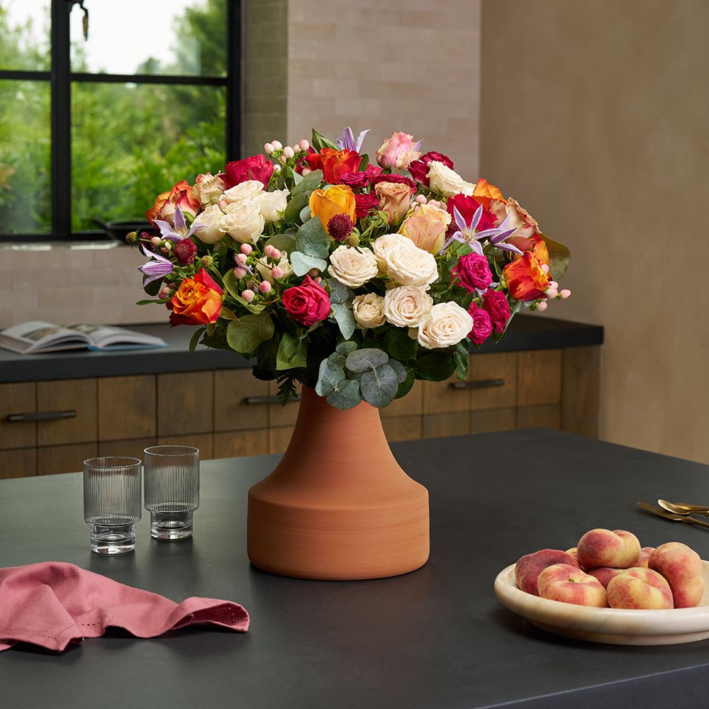 A luxury bouquet of roses in a terracotta vase