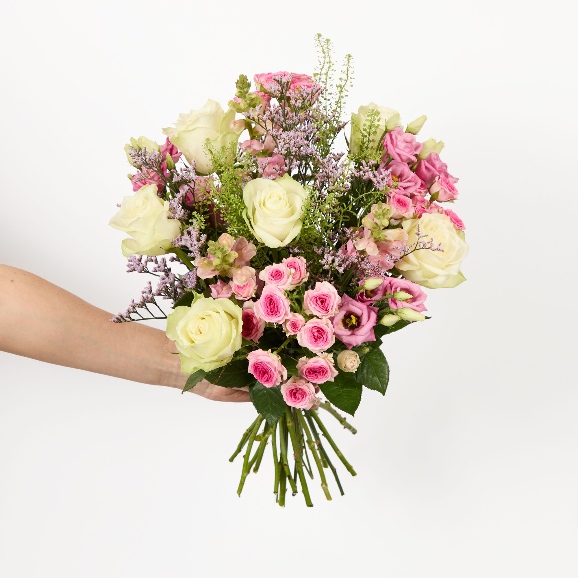 White roses, pink lisianthus, pink antirrhinum, pink limonium, ‘tralala’ spray roses and greenbell