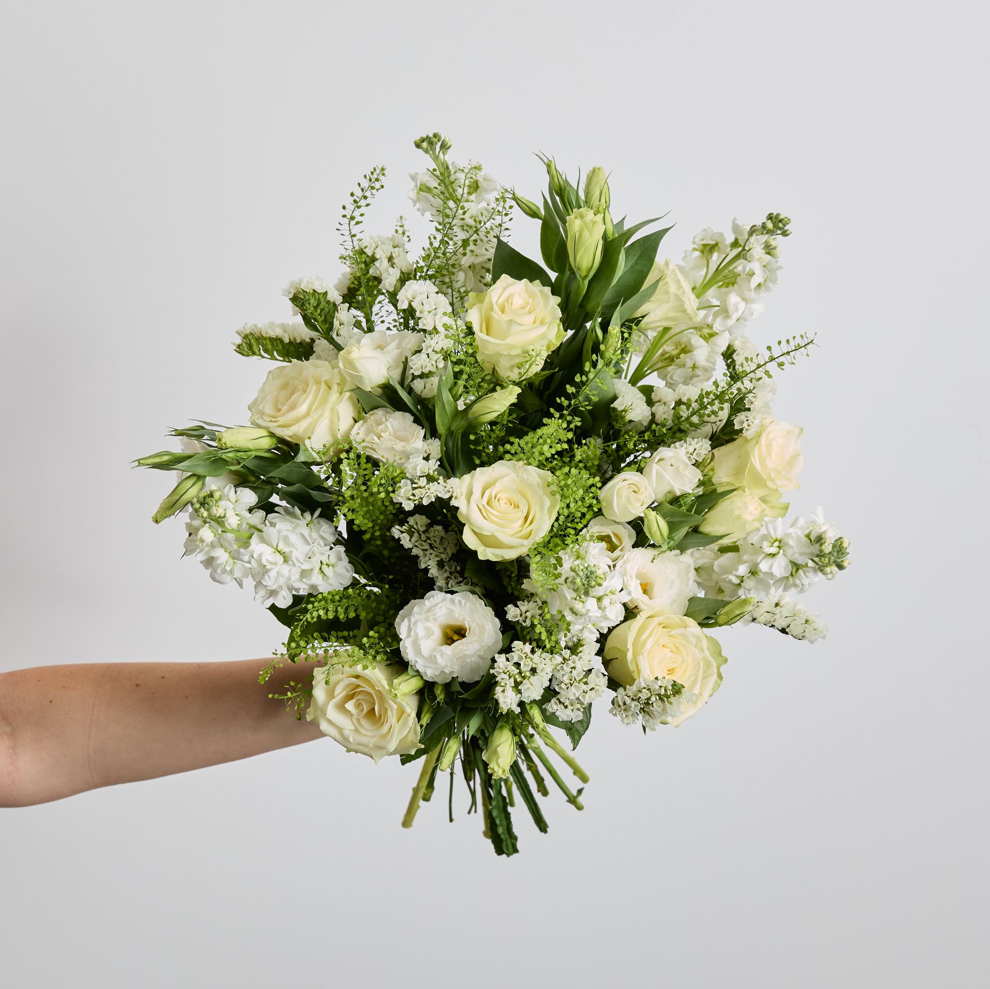 White roses, stocks, lisianthus, statice and greenbell
