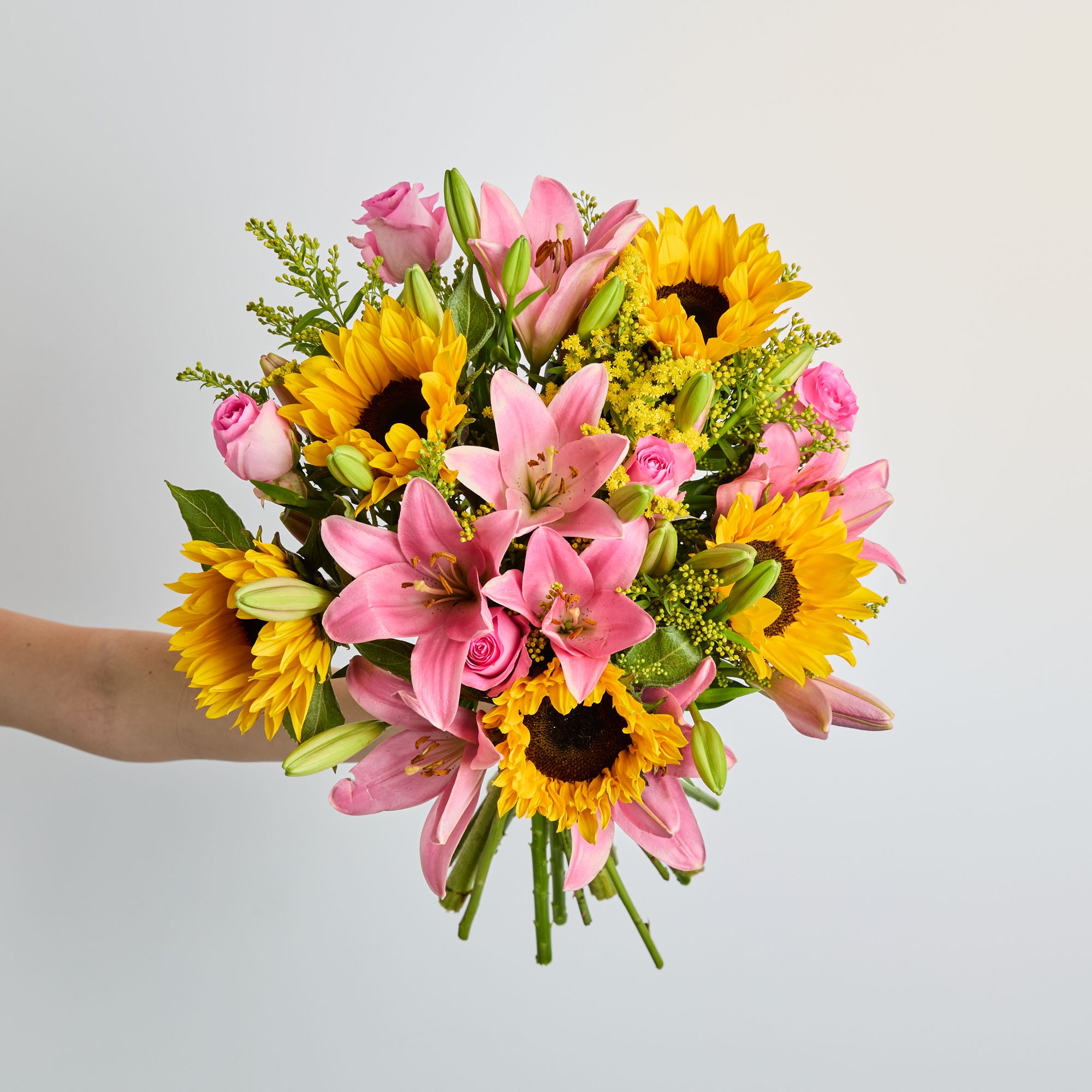 Pink lilies, sunflowers, solidago and pink roses