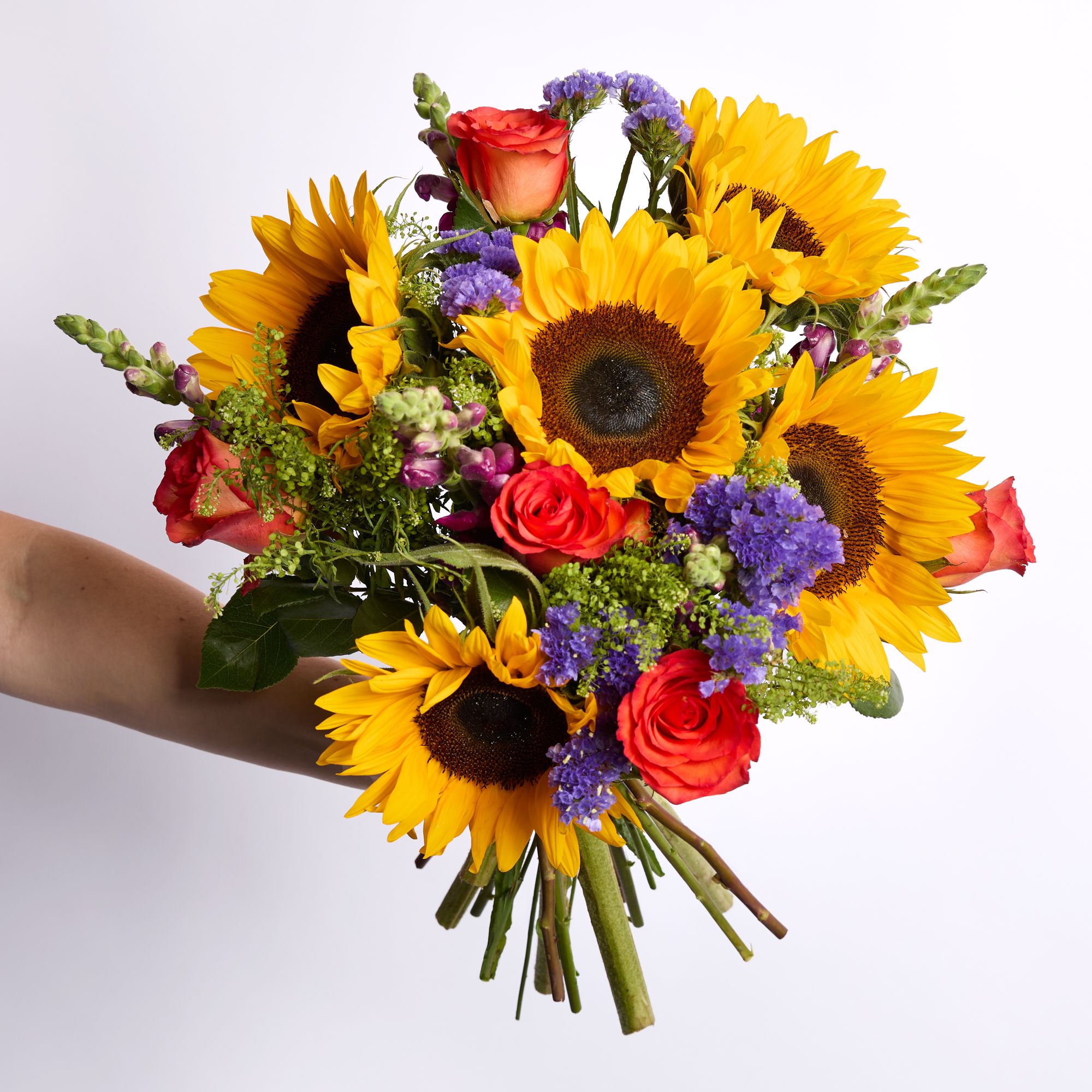 Sunflowers, orange roses, burgundy antirrhinum, purple statice and greenbell