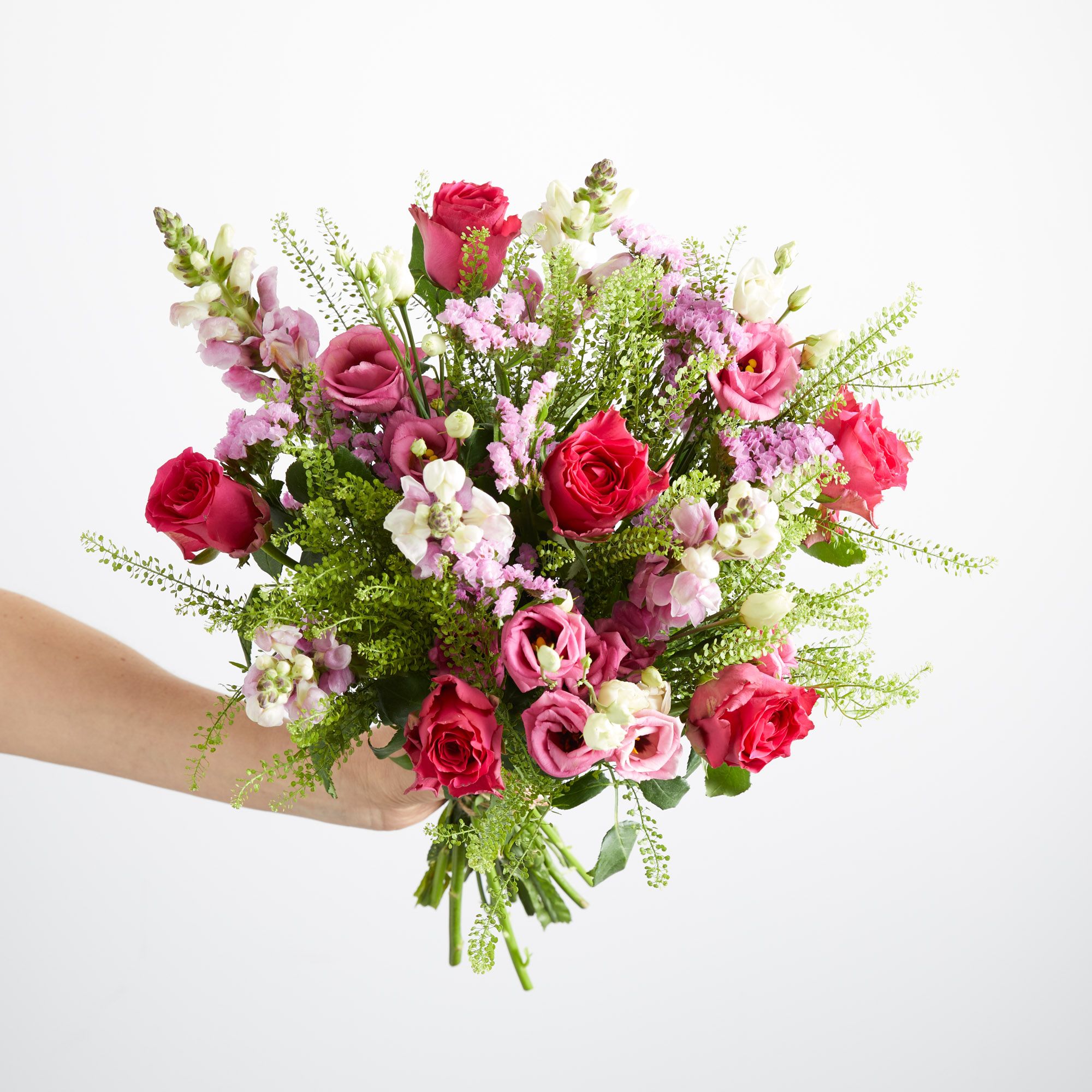 Cerise roses, lisianthus, antirrhinum, statice and greenbell