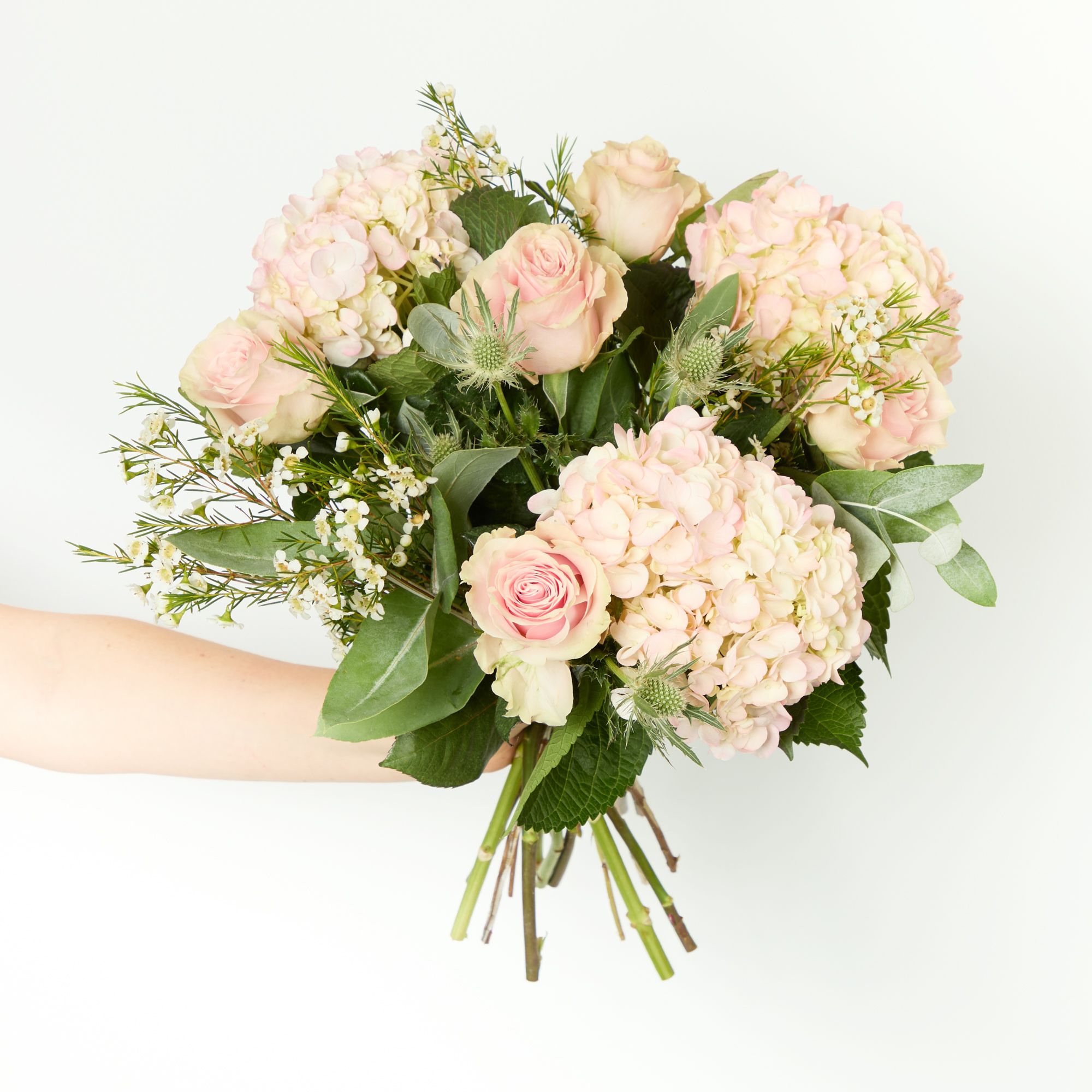 'Pink Tinted' hydrangeas, 'Pink Mondial' roses, white eryngium, white waxflowers and eucalyptus robusta