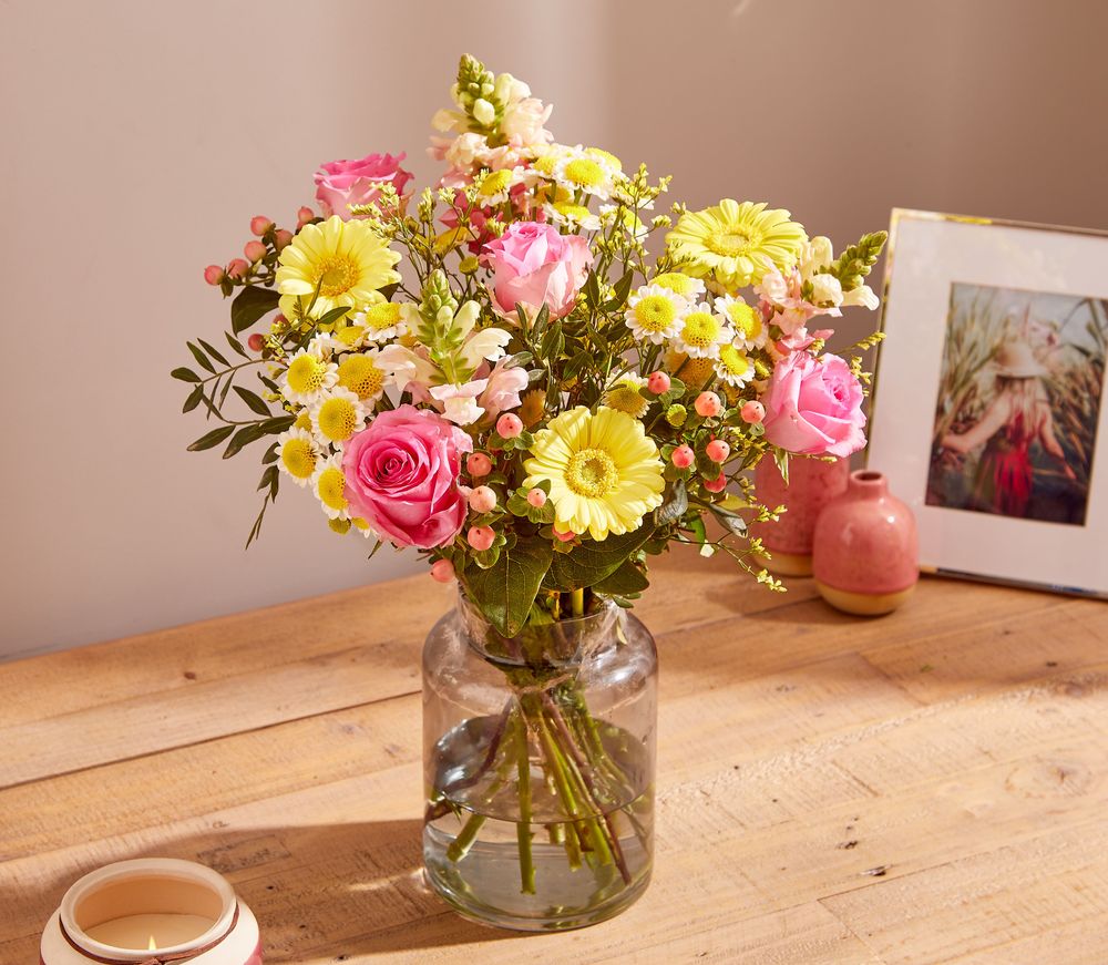 A bouquet of yellow Germini Gerbera, pink Roses, pink Antirrhinum, pink Hypericum and yellow Chrysanthemum Santini.